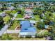 Expansive aerial view of a charming neighborhood with lush green lawns and waterways in the background at 108 Dee St, New Smyrna Beach, FL 32168