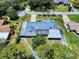 Aerial shot of a house featuring a distinctive roof, carport and attractive landscaping at 108 Dee St, New Smyrna Beach, FL 32168