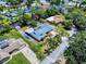 This is an aerial view of a house featuring a unique metal roof, large yard, and is near a canal at 108 Dee St, New Smyrna Beach, FL 32168