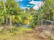 Scenic backyard view with mature trees and lush landscaping surrounding a tranquil pond at 108 Dee St, New Smyrna Beach, FL 32168