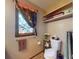 Bathroom featuring a toilet, towel rack, and window with decorative colored glass at 108 Dee St, New Smyrna Beach, FL 32168