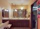 Bathroom with double sinks, granite countertops, unique lighting, and a shower with colorful curtain at 108 Dee St, New Smyrna Beach, FL 32168