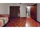 Bedroom featuring hardwood flooring, closet, and entry into another room at 108 Dee St, New Smyrna Beach, FL 32168