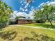 Charming single story brick home with a metal roof, mature trees and attached carport at 108 Dee St, New Smyrna Beach, FL 32168