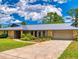 A single-story home featuring a metal roof, desert-style landscaping and lush green lawn at 108 Dee St, New Smyrna Beach, FL 32168