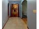 Arched hallway with tile flooring leading to a cozy living room with a stone fireplace at 108 Dee St, New Smyrna Beach, FL 32168