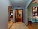 Hallway showcasing archways that lead to a stone fireplace and another room with hardwood flooring at 108 Dee St, New Smyrna Beach, FL 32168