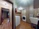 The spacious laundry room has an utility sink and updated washer and dryer at 108 Dee St, New Smyrna Beach, FL 32168