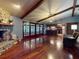 Inviting living room with stone fireplace, wood floors, and beamed ceilings at 108 Dee St, New Smyrna Beach, FL 32168