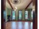 Living room boasting natural light through large windows and hardwood floors, creating a warm ambiance at 108 Dee St, New Smyrna Beach, FL 32168