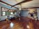 Bright living room features beamed ceilings and stone fireplace at 108 Dee St, New Smyrna Beach, FL 32168