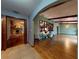 Spacious room with hardwood floors, wood beams and a glimpse of a stone fireplace at 108 Dee St, New Smyrna Beach, FL 32168