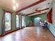 Spacious living room featuring wood floors, beamed ceilings, and large windows at 108 Dee St, New Smyrna Beach, FL 32168