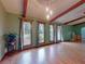 Bright living room featuring hardwood floors, exposed beams, and well-lit large windows at 108 Dee St, New Smyrna Beach, FL 32168
