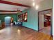 Open-concept living room with wood floors, beam ceilings and view to kitchen at 108 Dee St, New Smyrna Beach, FL 32168