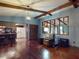 Cozy living room with beamed ceilings and open layout to the kitchen at 108 Dee St, New Smyrna Beach, FL 32168