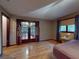 Well-lit main bedroom features hardwood floors and a screened patio at 108 Dee St, New Smyrna Beach, FL 32168