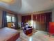 Well-lit main bedroom features an additional sitting area and hardwood floors at 108 Dee St, New Smyrna Beach, FL 32168