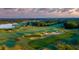 Breathtaking aerial view of the sprawling golf course showcasing manicured greens and sand traps at 113 Pitching Wedge Dr, Daytona Beach, FL 32124