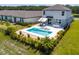 Aerial view of a home with a pool, patio, and fenced backyard overlooking a lake at 113 Pitching Wedge Dr, Daytona Beach, FL 32124