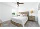 This bedroom offers neutral walls, a ceiling fan, a large bed and carpeted floor at 113 Pitching Wedge Dr, Daytona Beach, FL 32124