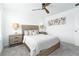 Cozy bedroom with carpet, ceiling fan, woven headboard, and side tables at 113 Pitching Wedge Dr, Daytona Beach, FL 32124