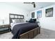 This bedroom offers neutral walls, a ceiling fan, a large bed, carpeted floor and a computer desk at 113 Pitching Wedge Dr, Daytona Beach, FL 32124