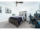 This bedroom offers neutral walls, a ceiling fan, a large bed, carpeted floor and a computer desk at 113 Pitching Wedge Dr, Daytona Beach, FL 32124