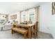 Bright dining area with a rustic wooden table set and large windows at 113 Pitching Wedge Dr, Daytona Beach, FL 32124