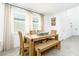 Bright dining area with a rustic wooden table set and large windows at 113 Pitching Wedge Dr, Daytona Beach, FL 32124