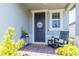 Inviting front porch with a 'Welcome' sign, rocking chair, and pleasant decorations at 113 Pitching Wedge Dr, Daytona Beach, FL 32124
