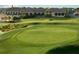 Scenic view of the lush green golf course with clubhouse in the background at 113 Pitching Wedge Dr, Daytona Beach, FL 32124