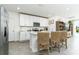 Bright kitchen with stainless steel appliances, white cabinets, and breakfast bar seating at 113 Pitching Wedge Dr, Daytona Beach, FL 32124