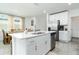 Modern kitchen with white cabinetry, stainless appliances, and a central island at 113 Pitching Wedge Dr, Daytona Beach, FL 32124
