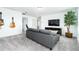 Upstairs living room featuring neutral paint, carpet, comfortable seating, mounted TV and lots of natural light at 113 Pitching Wedge Dr, Daytona Beach, FL 32124