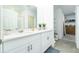 Bright main bathroom featuring dual sinks, a large mirror, and modern fixtures at 113 Pitching Wedge Dr, Daytona Beach, FL 32124