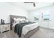 Serene main bedroom with natural light, plush bedding, and a ceiling fan at 113 Pitching Wedge Dr, Daytona Beach, FL 32124