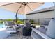 Inviting patio with comfortable seating, umbrella, and view of the backyard at 113 Pitching Wedge Dr, Daytona Beach, FL 32124