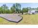 Community playground with a slide, swing set, and benches surrounded by lush trees at 113 Pitching Wedge Dr, Daytona Beach, FL 32124