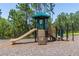 A fun playset with a slide and climbing area in a community park, perfect for outdoor activities at 113 Pitching Wedge Dr, Daytona Beach, FL 32124