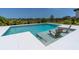 Modern pool with built-in lounge chairs for relaxing in the sun at 113 Pitching Wedge Dr, Daytona Beach, FL 32124