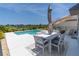 Beautiful backyard oasis with a pristine pool and outdoor dining area at 113 Pitching Wedge Dr, Daytona Beach, FL 32124