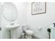 Clean and modern powder room with a pedestal sink and decorative accents at 113 Pitching Wedge Dr, Daytona Beach, FL 32124