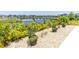 Landscaped backyard with decorative rock, plants, and a tranquil lake view at 113 Pitching Wedge Dr, Daytona Beach, FL 32124