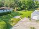 Aerial view of the property showing the house, large yard, and detached garage at 1144 Corbin Park Rd, New Smyrna Beach, FL 32168