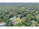 Aerial neighborhood view with mature trees, well-kept lawns, and visible swimming pools at 1144 Corbin Park Rd, New Smyrna Beach, FL 32168