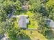 Aerial view of property featuring fenced yard, mature trees, and detached garage at 1144 Corbin Park Rd, New Smyrna Beach, FL 32168