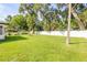 Large fully fenced backyard with green space, lush trees, and serene atmosphere at 1144 Corbin Park Rd, New Smyrna Beach, FL 32168