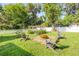 The backyard features lush landscaping, a white picket fence, and comfortable seating at 1144 Corbin Park Rd, New Smyrna Beach, FL 32168