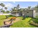 Backyard featuring a screened-in porch, stone patio, and lush green lawn at 1144 Corbin Park Rd, New Smyrna Beach, FL 32168
